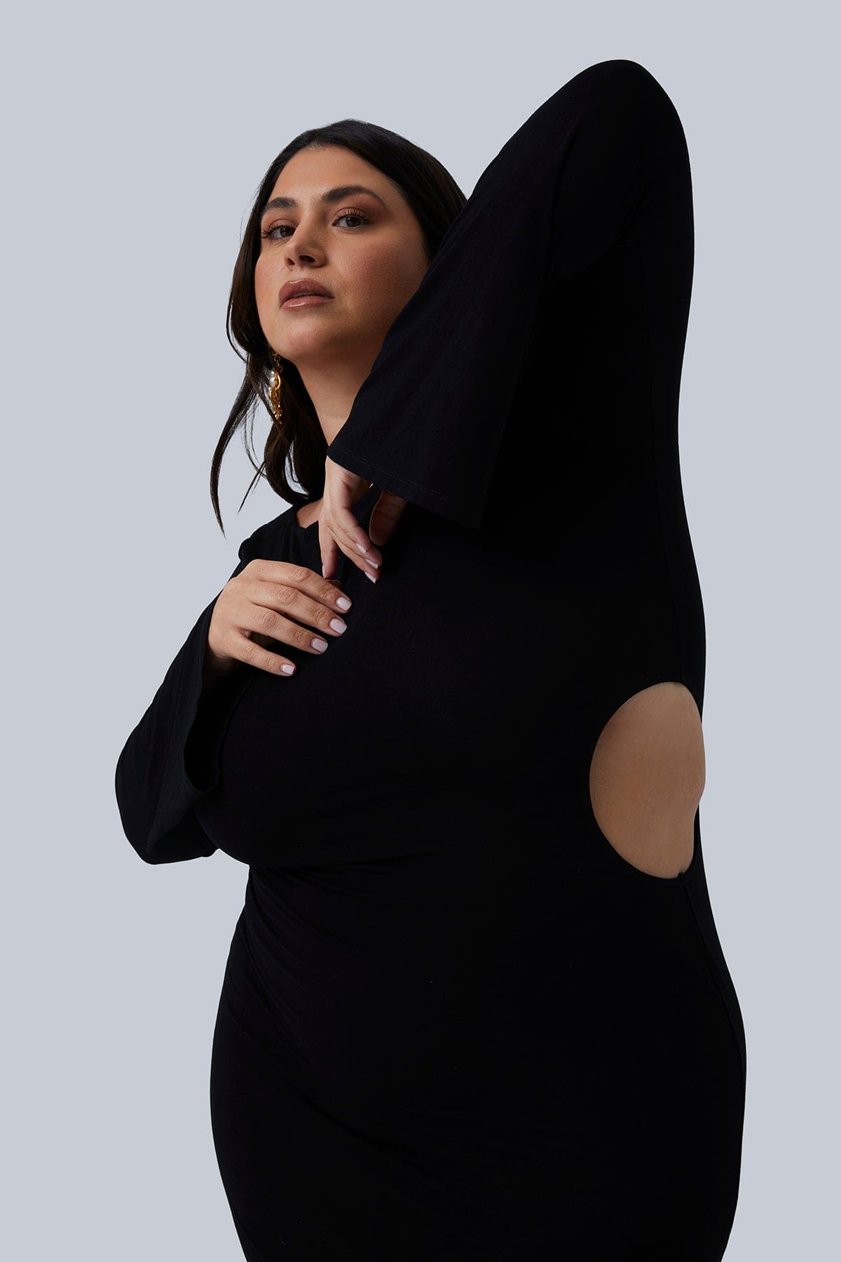 Close up of Gia IRL dress Gabrielle Maxi side cutout detail. This is a long black dress with flared sleeves size 1X. Plus size women's fashion size 12-26.
