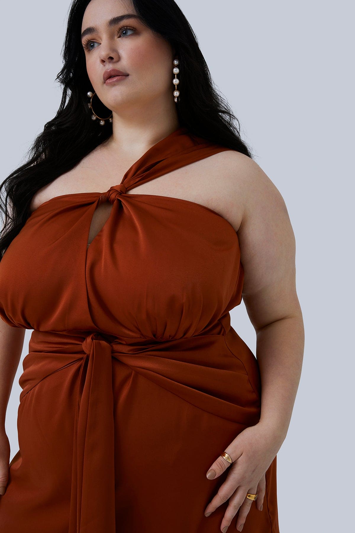 Silk Maya Mini Dress in Rust size 18 for plus size women worn by plus size fashion model with long dark hair in loose waves and gold hoops with pearls.