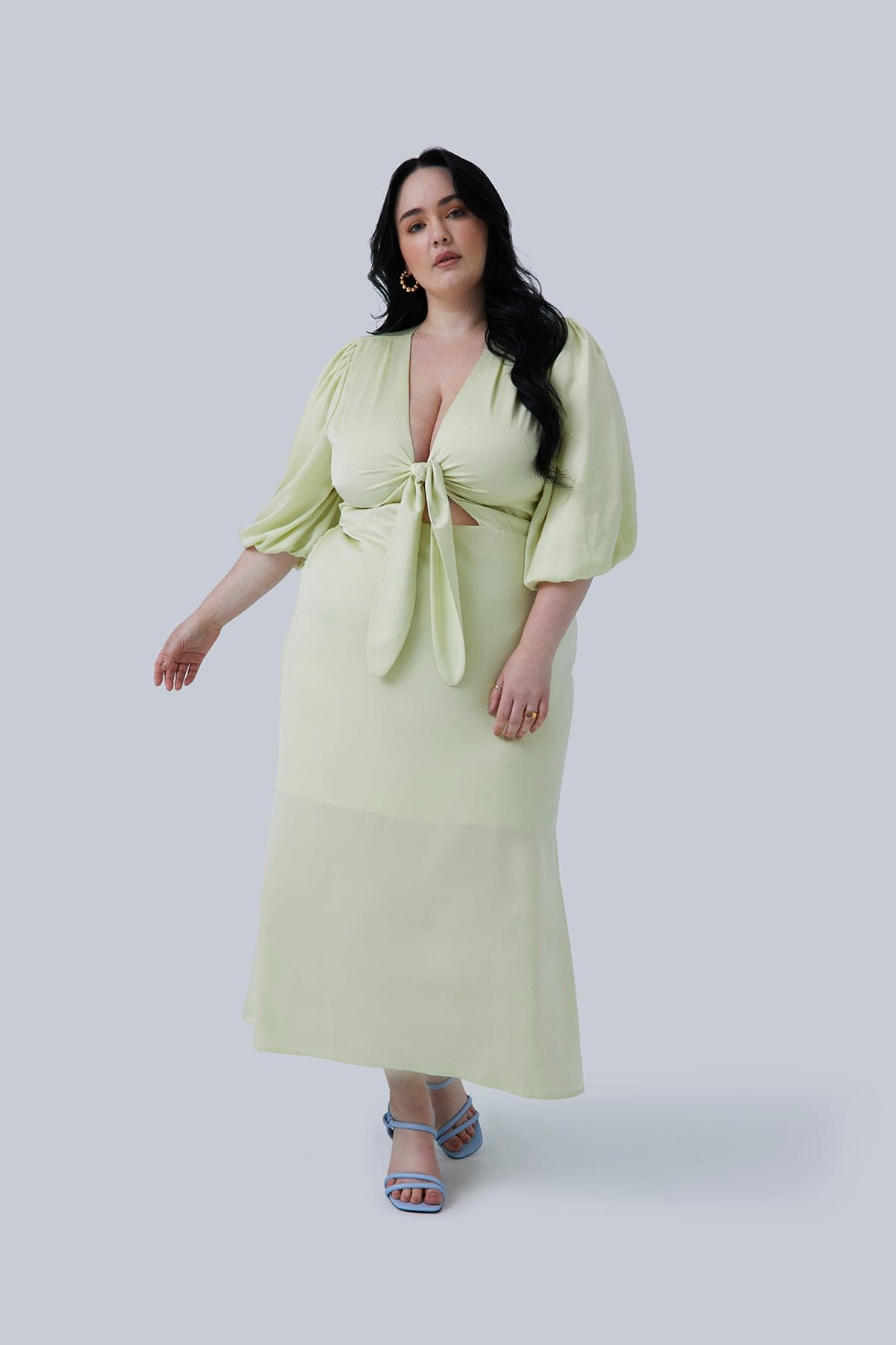 Tie Front Midi Dress with Waist Cutout and Bubble Sleeve. Allie Maxi by Gia IRL size 20 color Citron. Model is taking a step forward wearing plus size fashion for women.