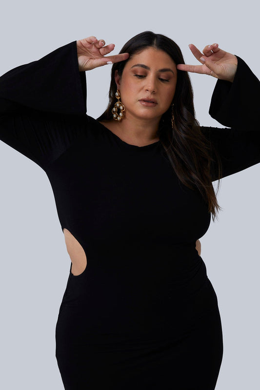 The Gabrielle Maxi dress by Gia IRL in black size 1X. Flared sleeves and side cutout in this long black maxi dress with double layer stretch fabric. Plus size dress for women available size 12-26.