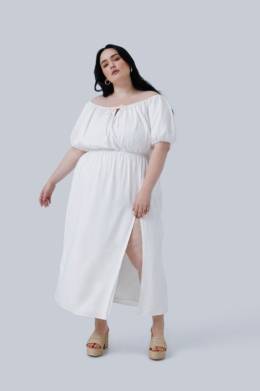 Model wearing Gia midi dress in size 3X. Dress is swaying and both arms as well. Dress is slightly off the shoulder (can be worn on or off). Perfect plus size dress for travel.