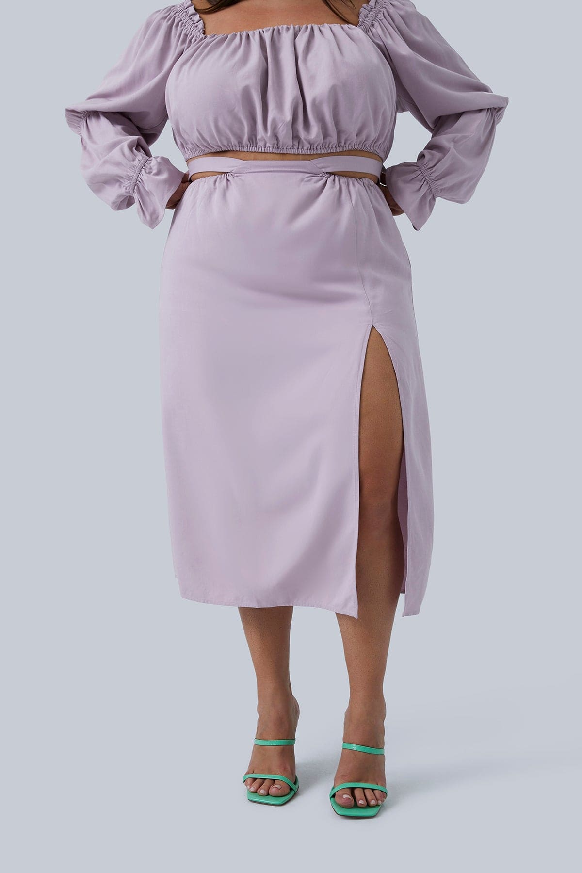 Full length view of the Gia Skirt size 2X in lilac. Slit is thigh high and this plus size skirt can be paired with the Gia top also shown here.