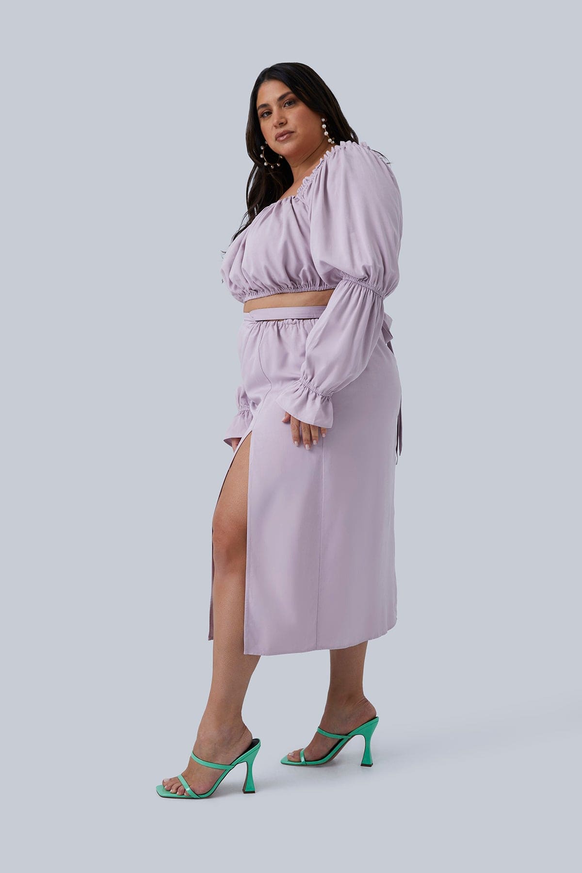Side slit view of the Gia Skirt size 2X. Model is the founder of Gia IRL, Gia Sinatra, plus size model and body positivity advocate. Gia is also wearing the Gia Top which is sold separately from the skirt in a set for plus size women. Shop Gia IRL plus size boutique.