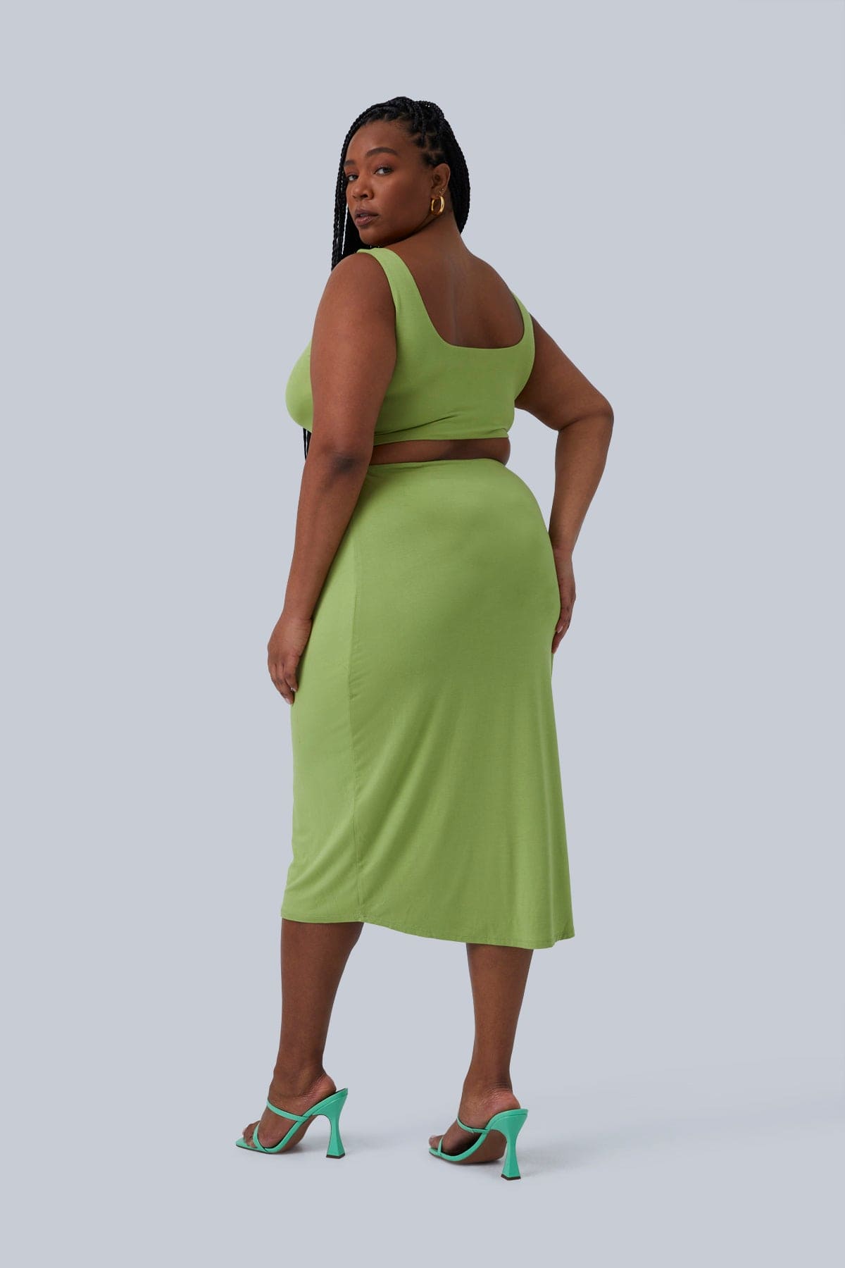 Back view of the Gigi Midi Dress with two layers of fabric for maximum shape for women with curves. Model is looking over her shoulder towards camera. Dress by Gia IRL Plus Size Boutique size 1X.