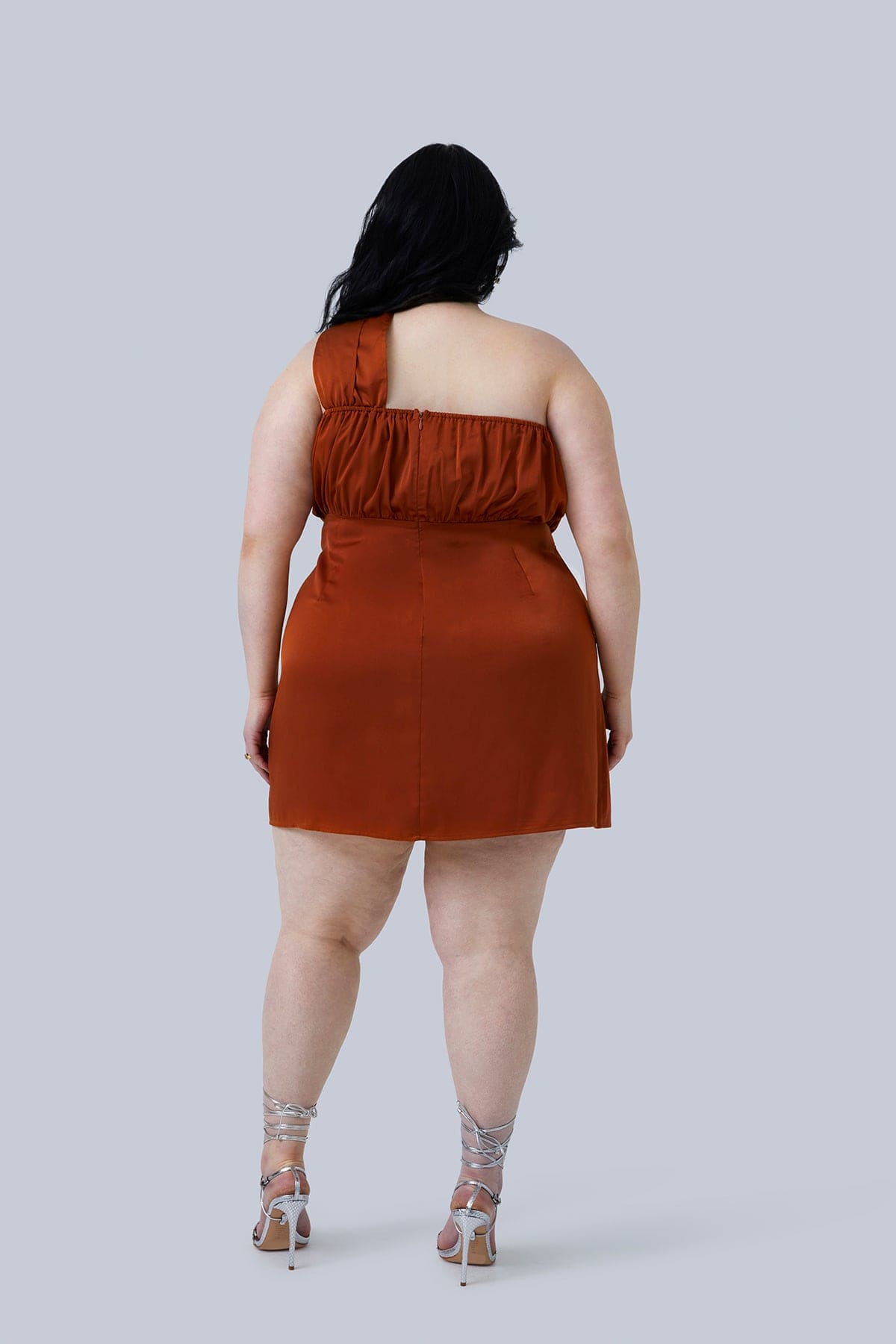 Back view of the Maya Mini Dress size 18 - perfect going out dress for plus size women heading out for a fun evening. This one shoulder, silk mini dress looks perfect in rust.